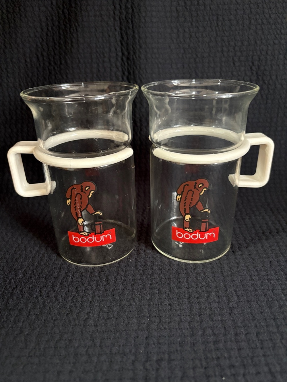 Bodum Clear Glass Monkey Mugs with White Handles and Red Logo (Pair)